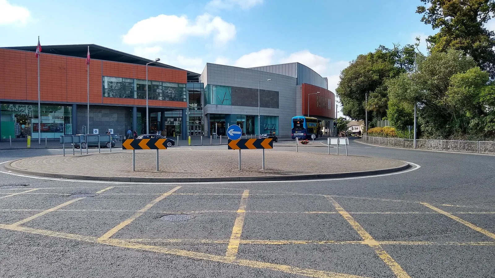 The entrance of Swords Pavilions Shopping Centre beyond a roundabout, outside which Swords On Ice sets up — Swords On Ice