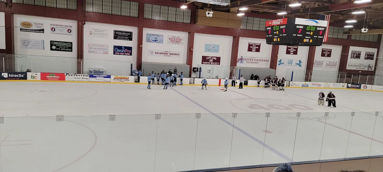 The single sheet at Talbot Rink with its maroon-and-white wall panels, scoreboard and wooden bleachers. — Talbot Rink