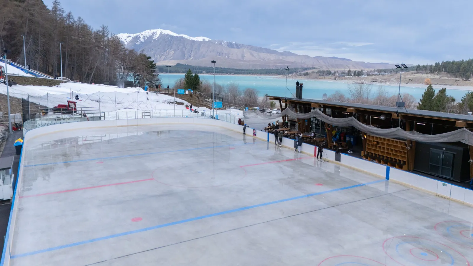 The outdoor ice rink at Tekapo Springs with Lake Tekapo and the mountains behind — Tekapo Springs Ice Rink