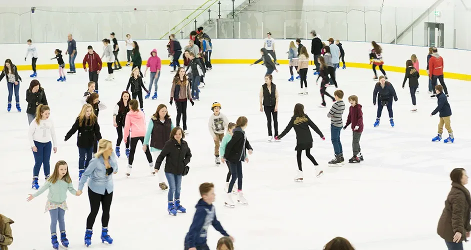 A busy public session on the ice at Telford, skaters of all ages spread across the white surface. — Telford Ice Rink