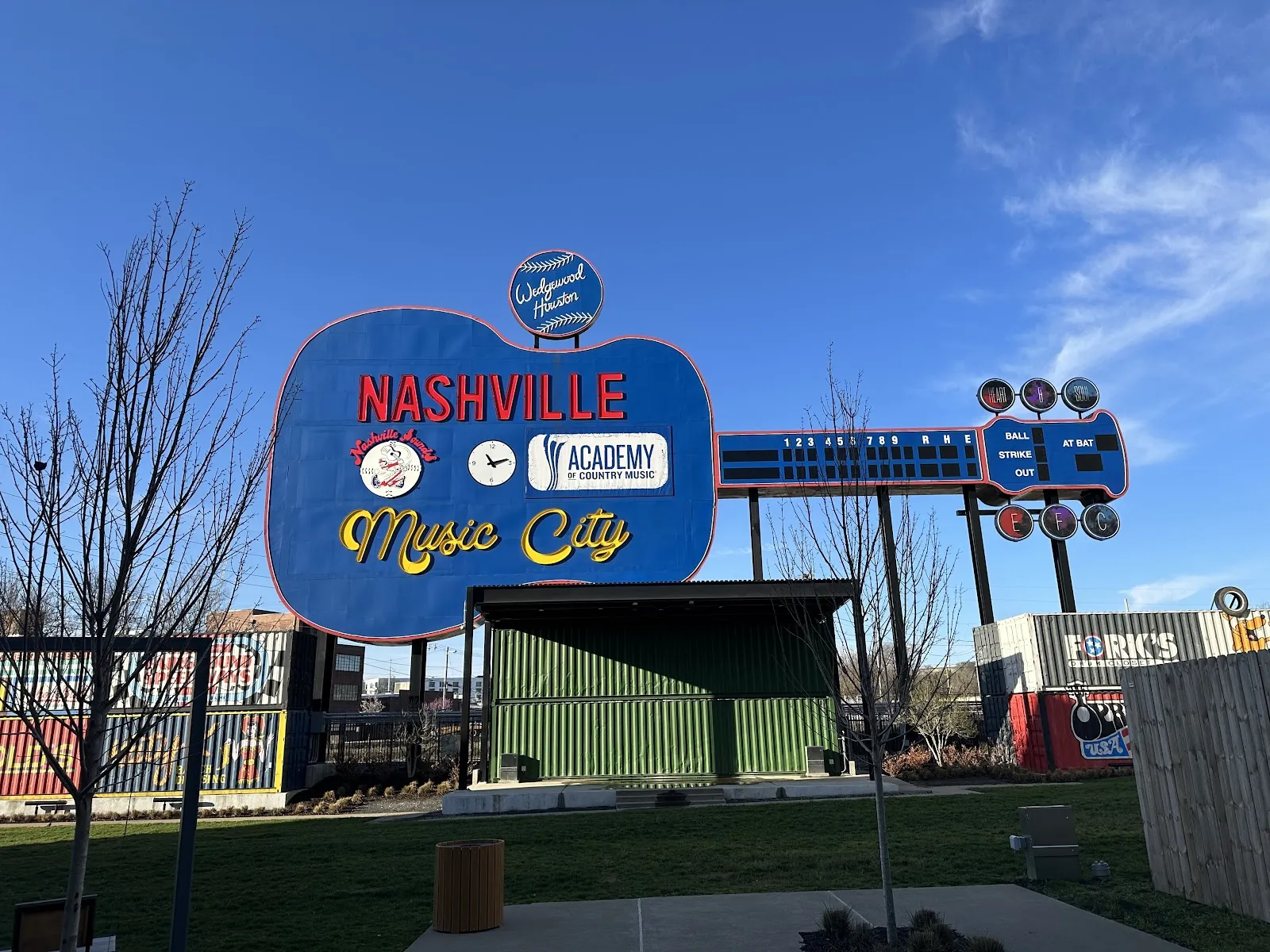 The Giant Guitar scoreboard and the lawn of The Outfield, where The Rink Under the Giant Guitar is set up (Google Maps listing photo; the rink opens November 20, 2026) — The Rink Under the Giant Guitar
