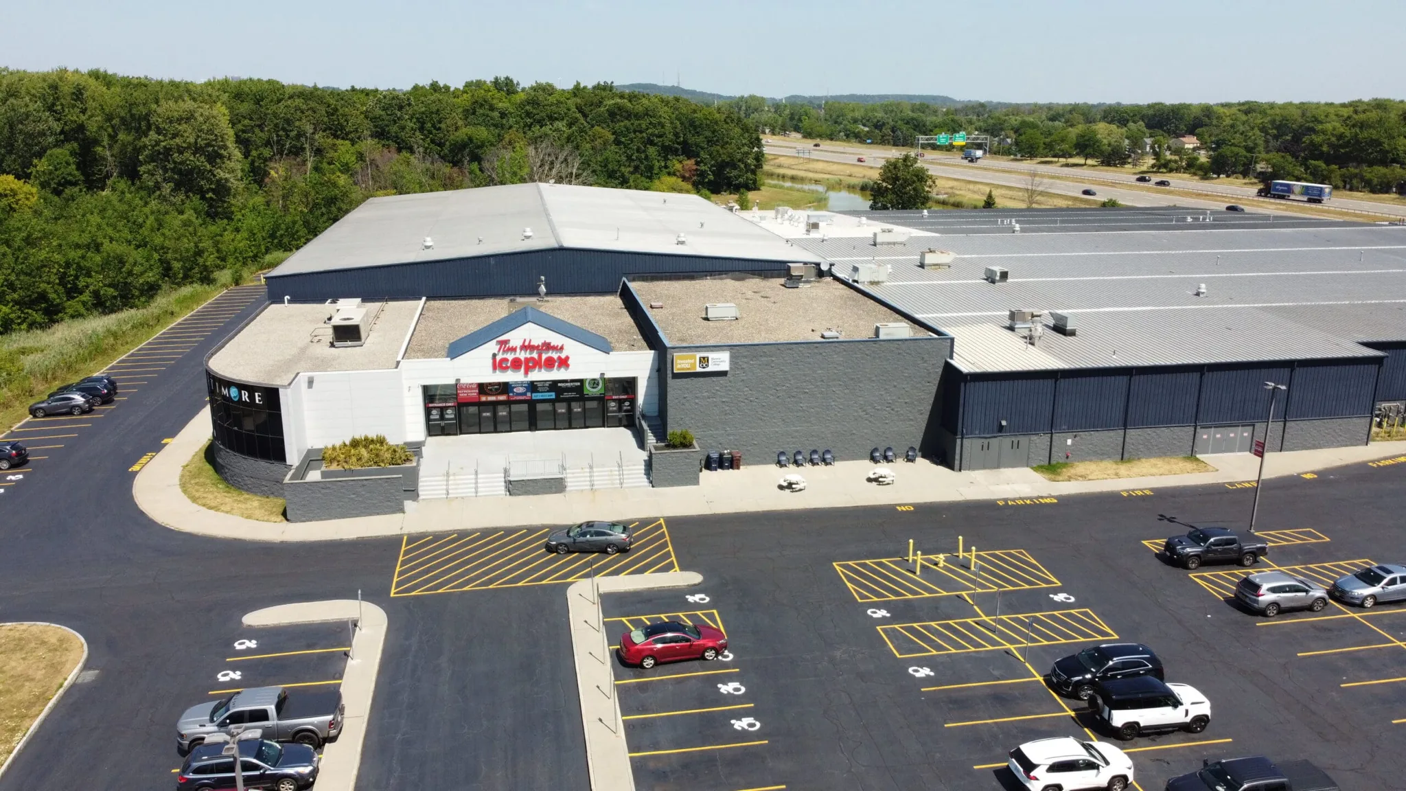 Iceplex's low grey-and-white arena block — Tim Hortons Iceplex
