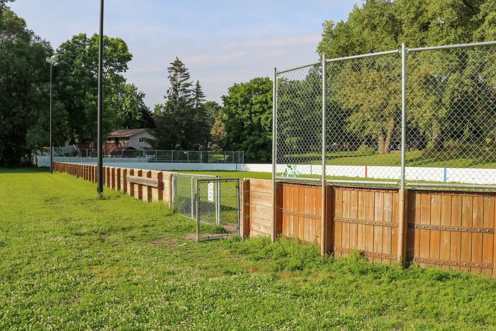 Timberland Knolls outdoor rink with grass (City of Burnsville page photo, taken when the rink is not iced) — Timberland Knolls Park Outdoor Rink