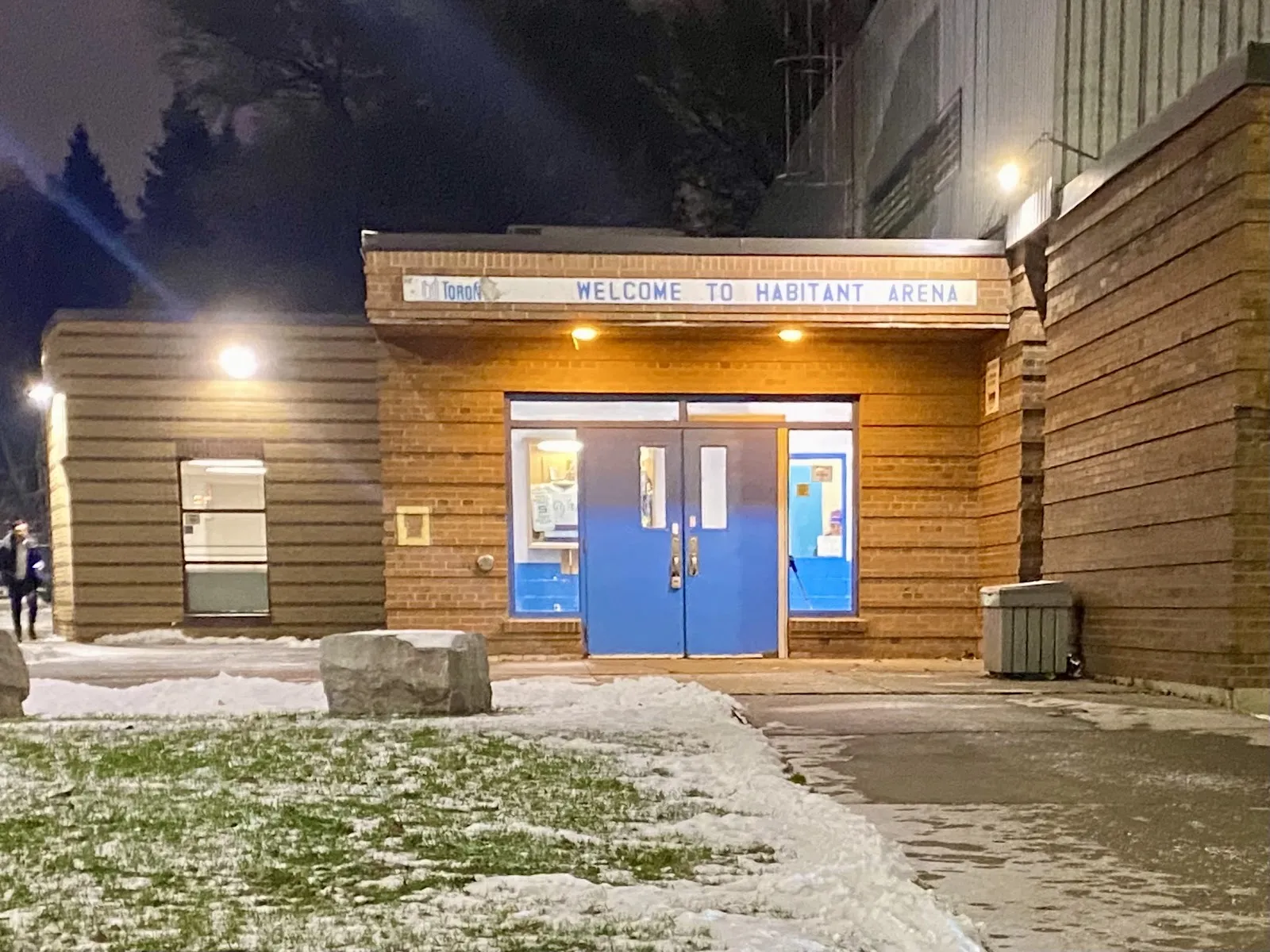 The lit brick entrance of the Habitant Arena on Weston Road in Toronto, under its Welcome to Habitant Arena sign — Habitant Arena