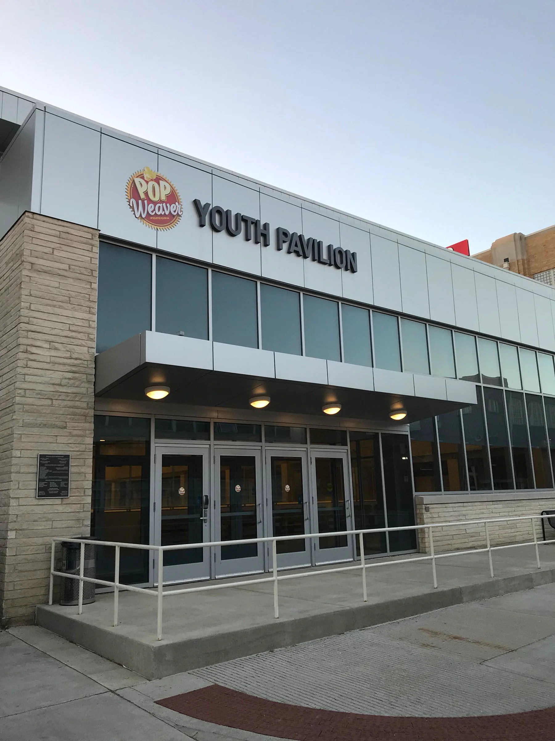 Main entrance of the Pop Weaver Youth Pavilion at dusk — TPH Indy Rinks at the Indiana State Fairgrounds