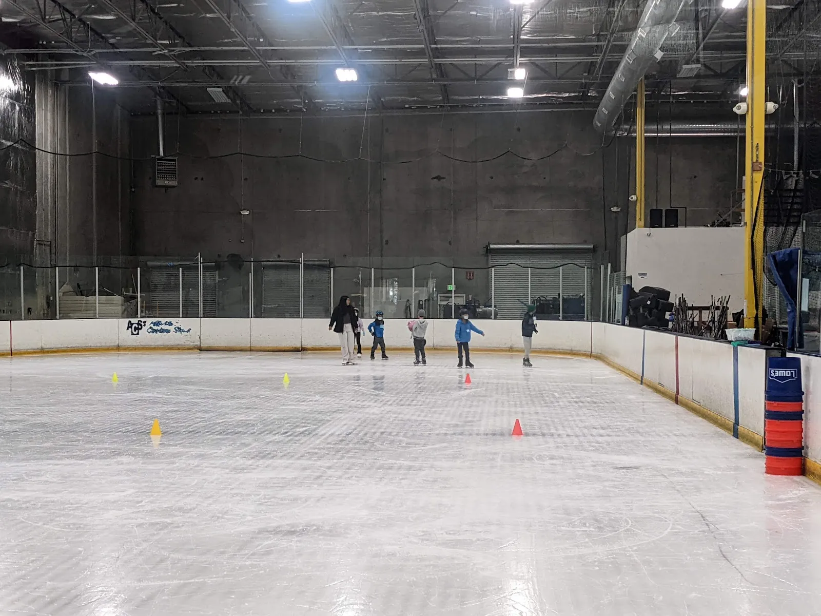 The ice sheet at Tri-Valley Ice with a small group of skaters at a distance — Tri Valley Ice (Livermore)
