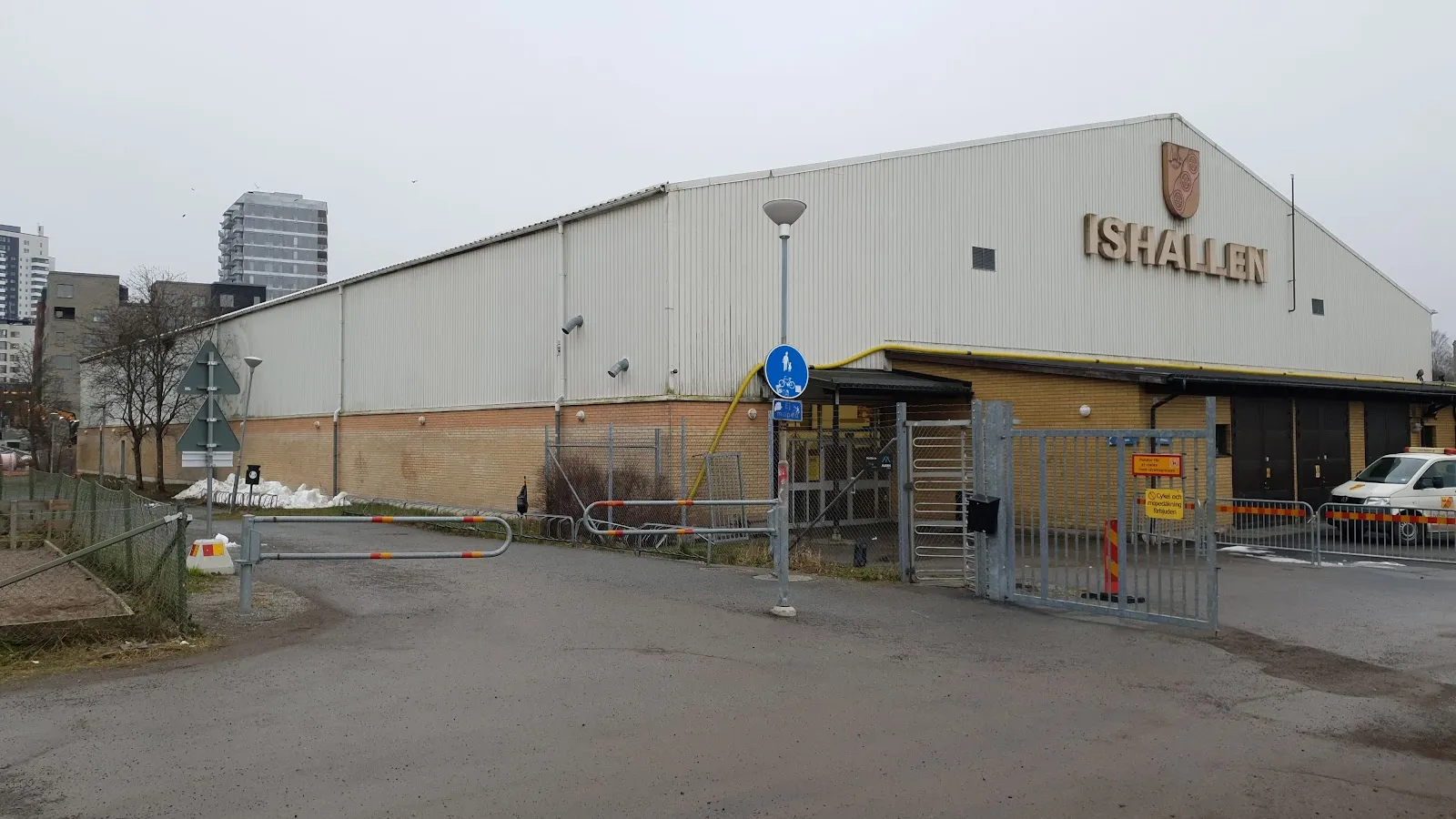 Tyresö ishall seen from the road, with the ISHALLEN sign on the façade — Tyresö ishall