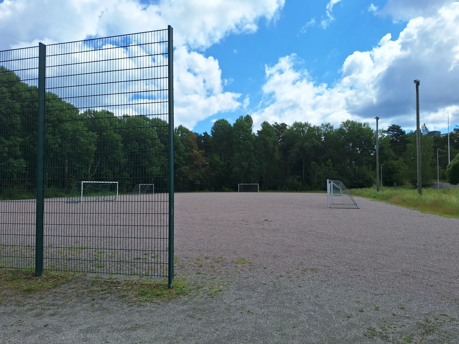 The Uittamon field in summer, a ball field with a gravel (stone-dust) surface with goals; the City of Turku freezes its fields into skating fields in winter. — Uittamon luistelukenttä