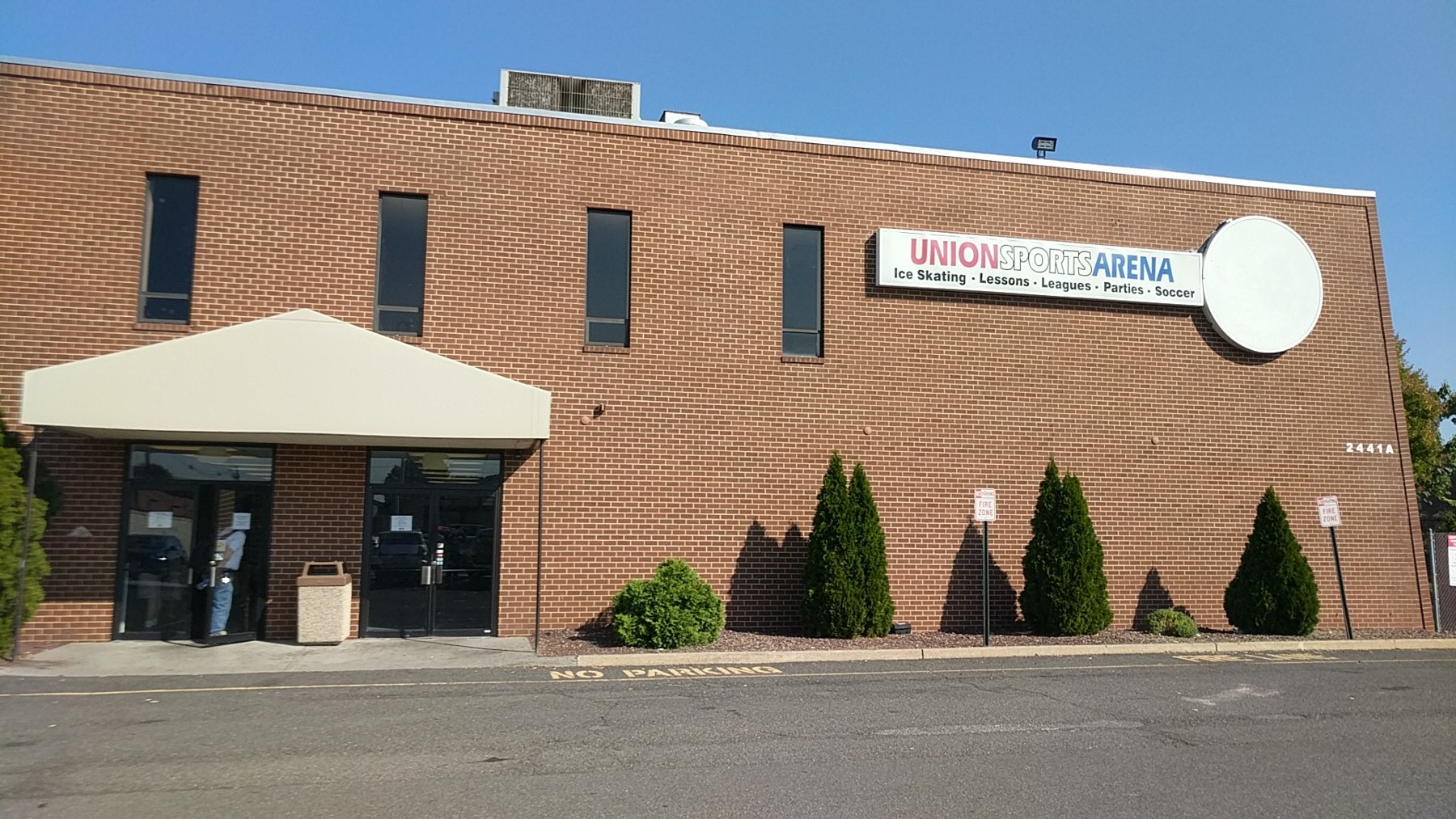 The signed entrance and brick frontage of Union Sports Arena. — Union Sports Arena