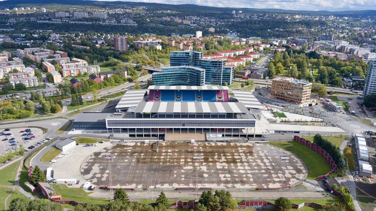Valle Hovin fra luften, stadionets tribuner ved siden av hurtigløpsovalen og nabolaget rundt i Oslo. — Valle Hovin stadion