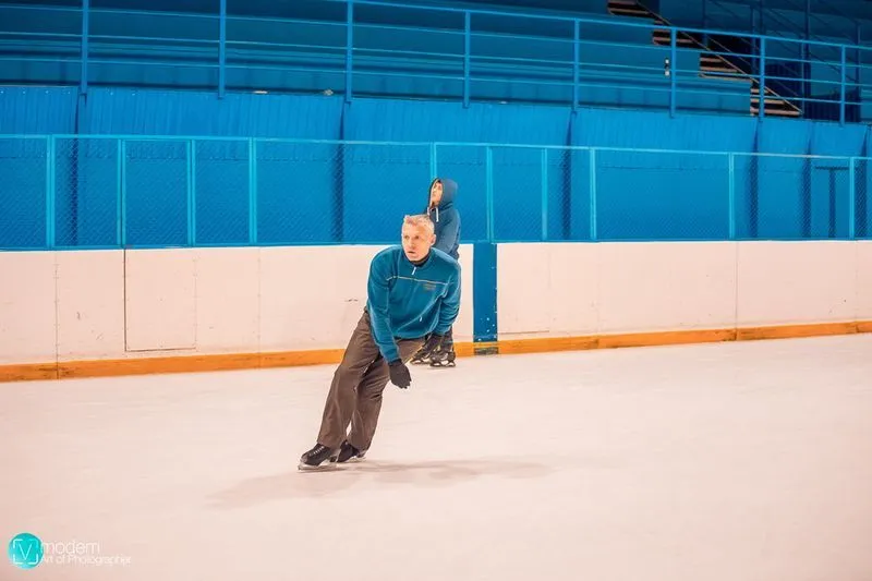 A skater crossing the Varyag ice in front of the blue boards, from the rink's own photo gallery — Varyag Sports Park Ice Rink Bryansk