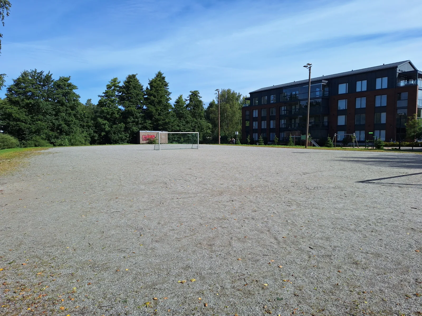 The Vätin field in summer, a ball field with a gravel (stone-dust) surface with goals; the City of Turku freezes its fields into skating fields in winter. — Vätin luistelukenttä