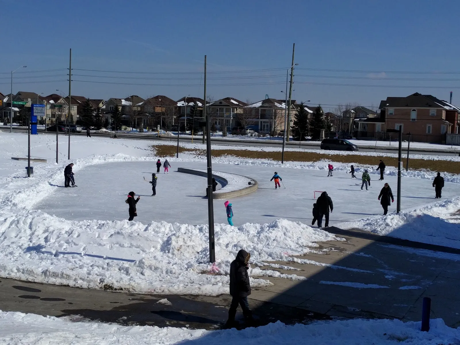 Skaters on the outdoor skating pad at Vellore Village in winter — Vellore Village Community Centre Outdoor Rink (Vaughan)