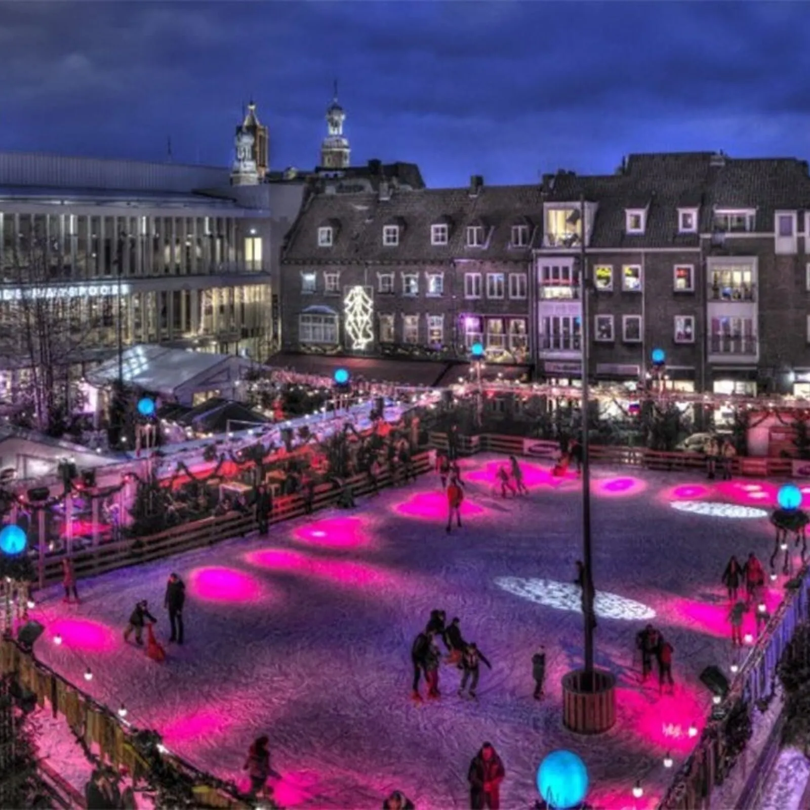 Venlo on Ice op de Oude Markt bij schemering, met de ijsbaan roze verlicht – Venlo on Ice