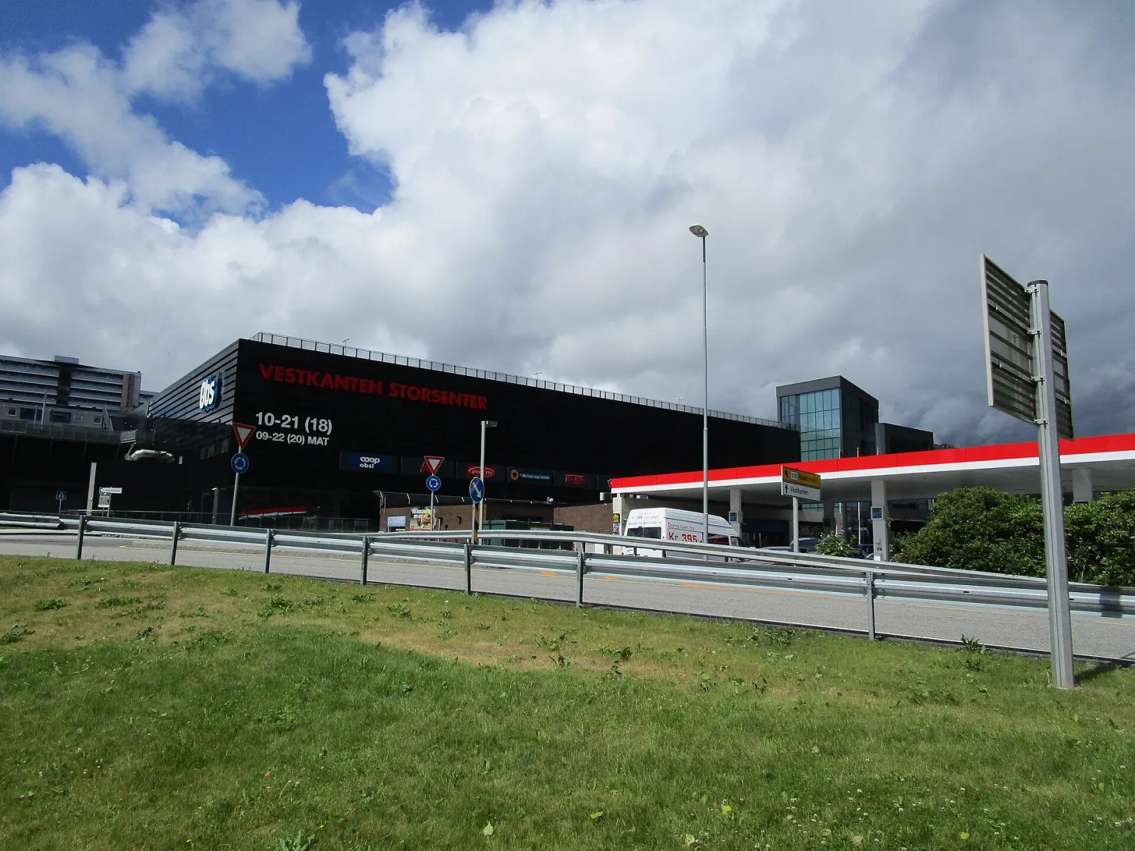 The dark Vestkanten Storsenter building seen across the road; Iskanten ice hall is inside the Thon centre. — Vestkanten Ishall (Iskanten)