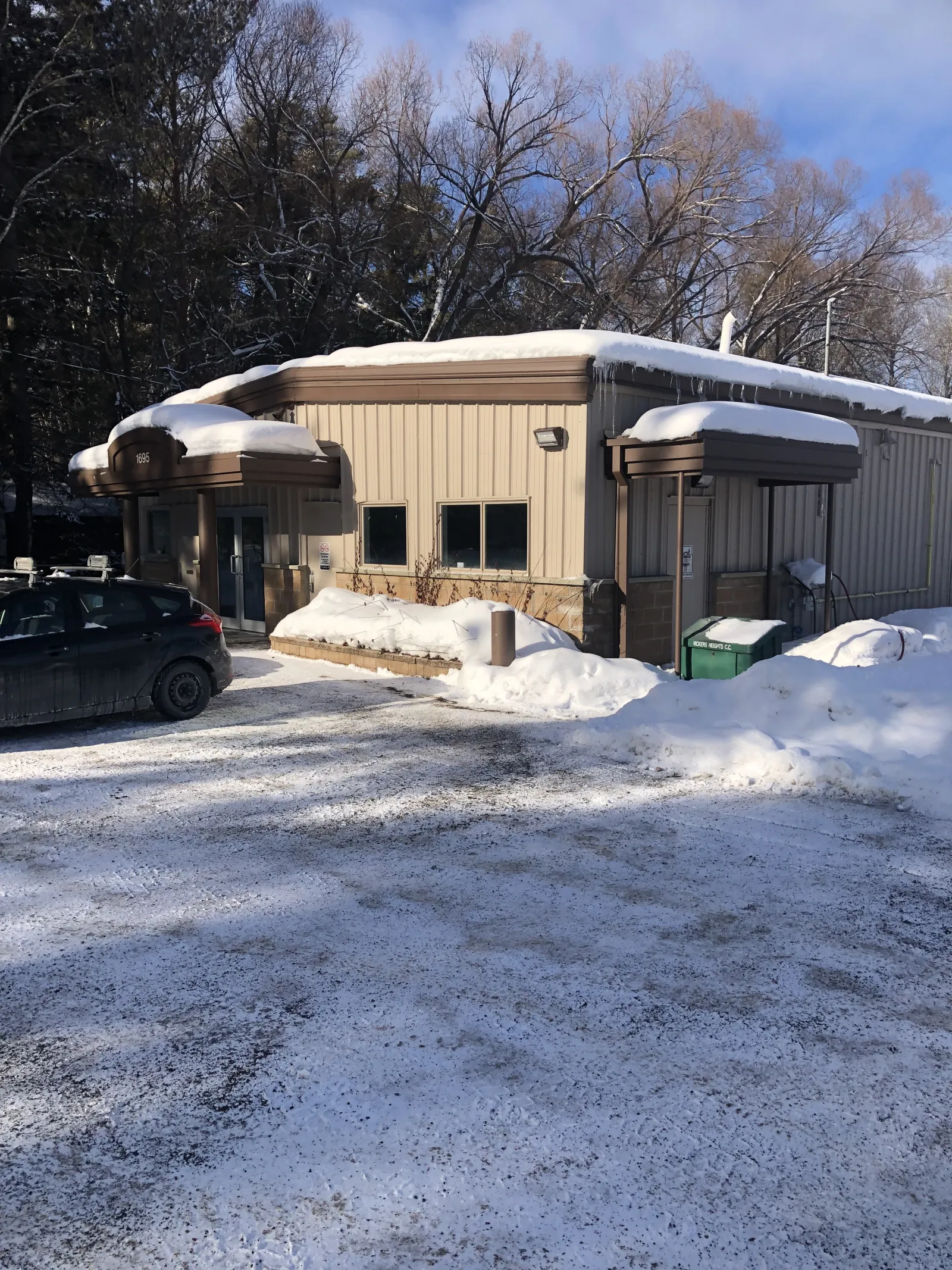 The Vickers Heights Community Centre building at the edge of the parking area — Vickers Heights Community Centre Outdoor Rink