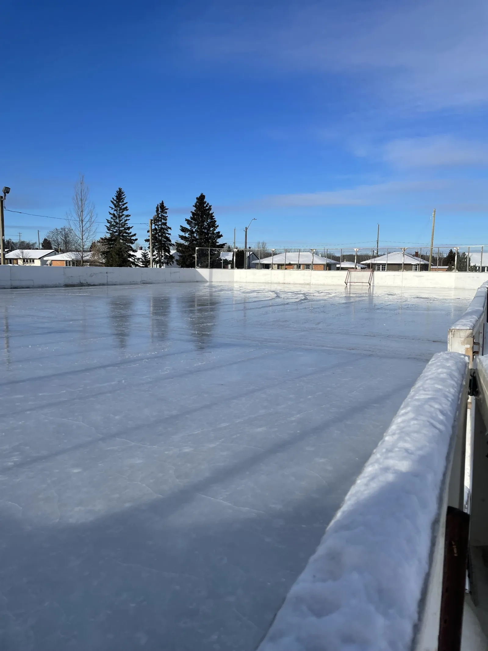 The boarded rink at Volunteer Pool Community Centre with a clear ice surface — Volunteer Pool Community Centre Outdoor Rink