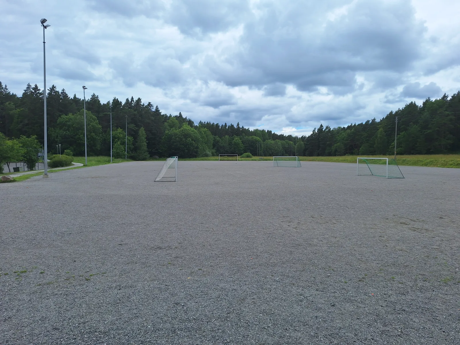 The Wäinö Aaltosen kenttä field in summer, a ball field with a gravel (stone-dust) surface with goals; the City of Turku freezes its fields into skating fields in winter. — Wäinö Aaltosen kenttä