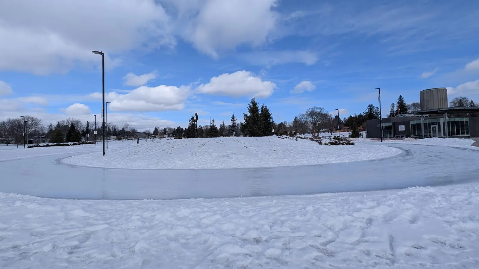 The looping ice path of the Waterdown Skating Loop in Memorial Park in winter with no people in view — Waterdown Memorial Park City Outdoor Rink