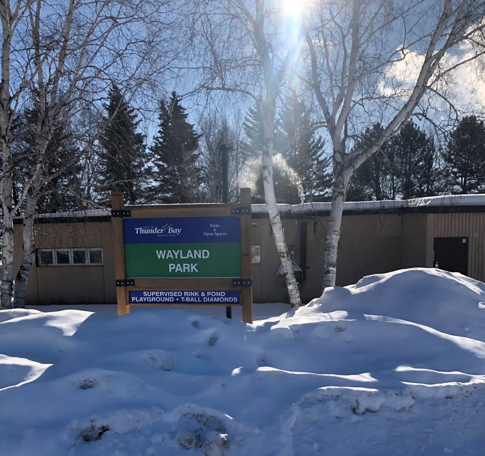 The Wayland Park sign at the field house beside the rink and pond — Wayland Park Outdoor Rinks