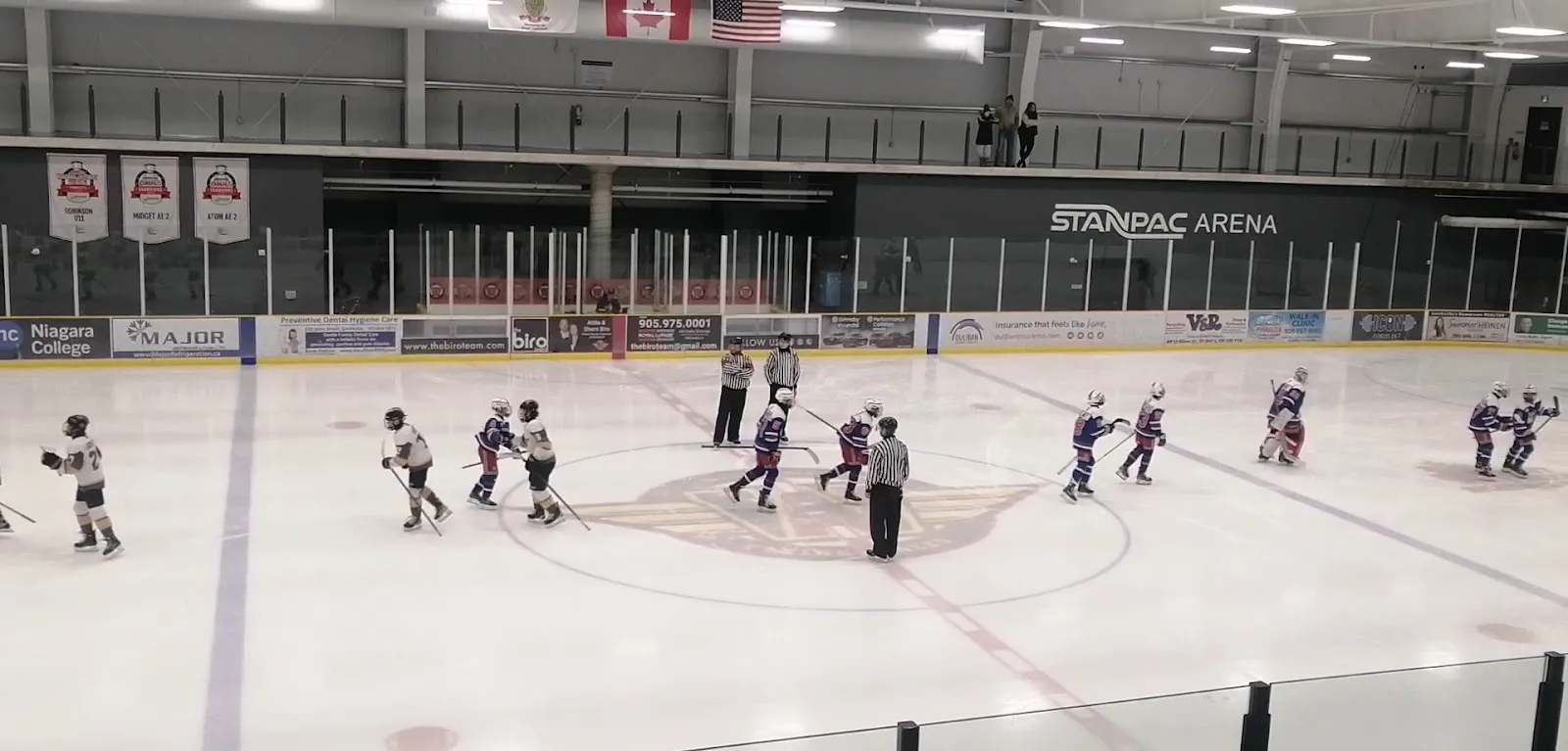 A group of young skaters spread across the ice during a session at West Lincoln Community Centre, with the arena wall behind. — West Lincoln Community Centre