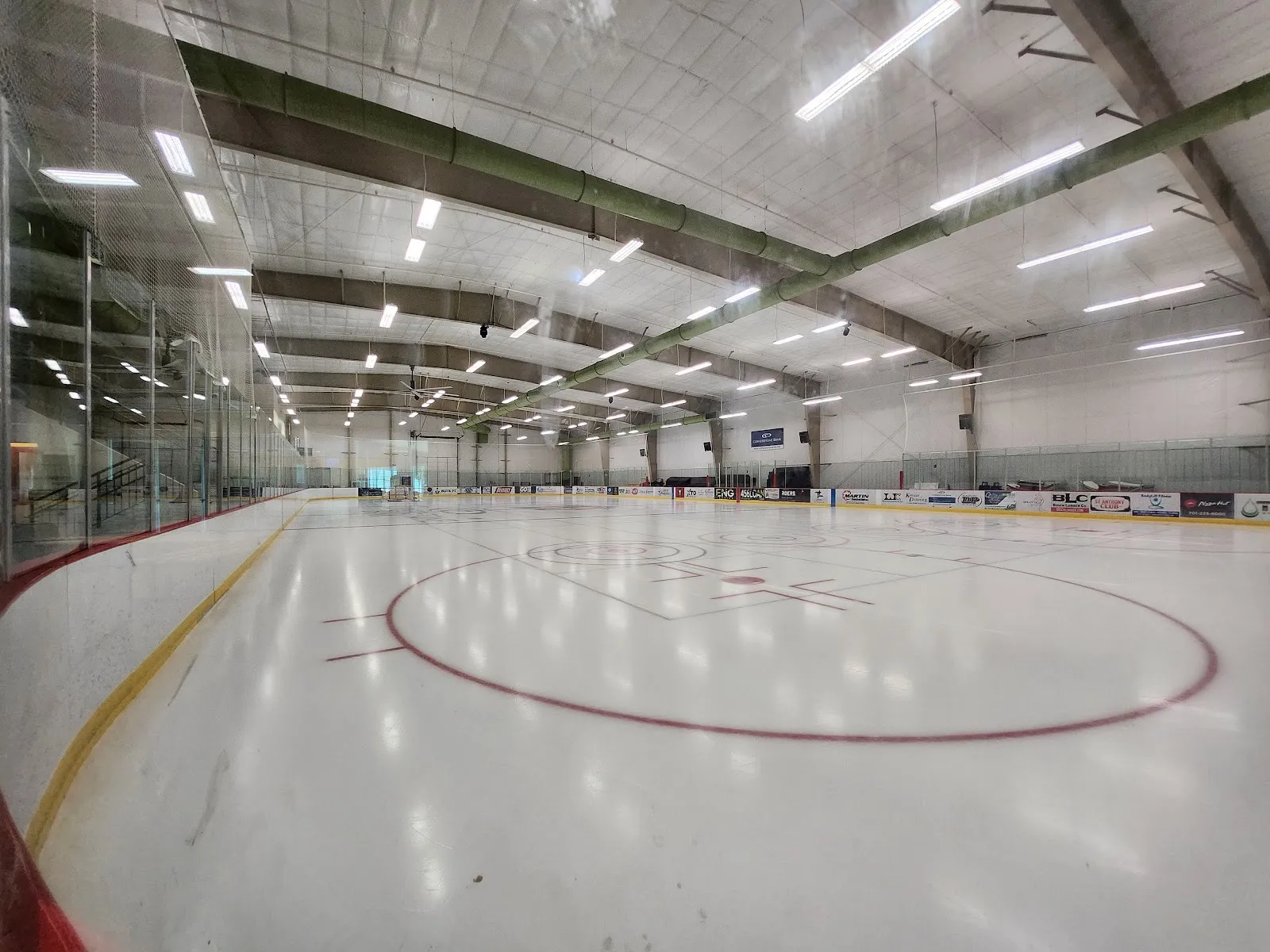 The empty ice sheet inside West River Ice Center — West River Ice Center