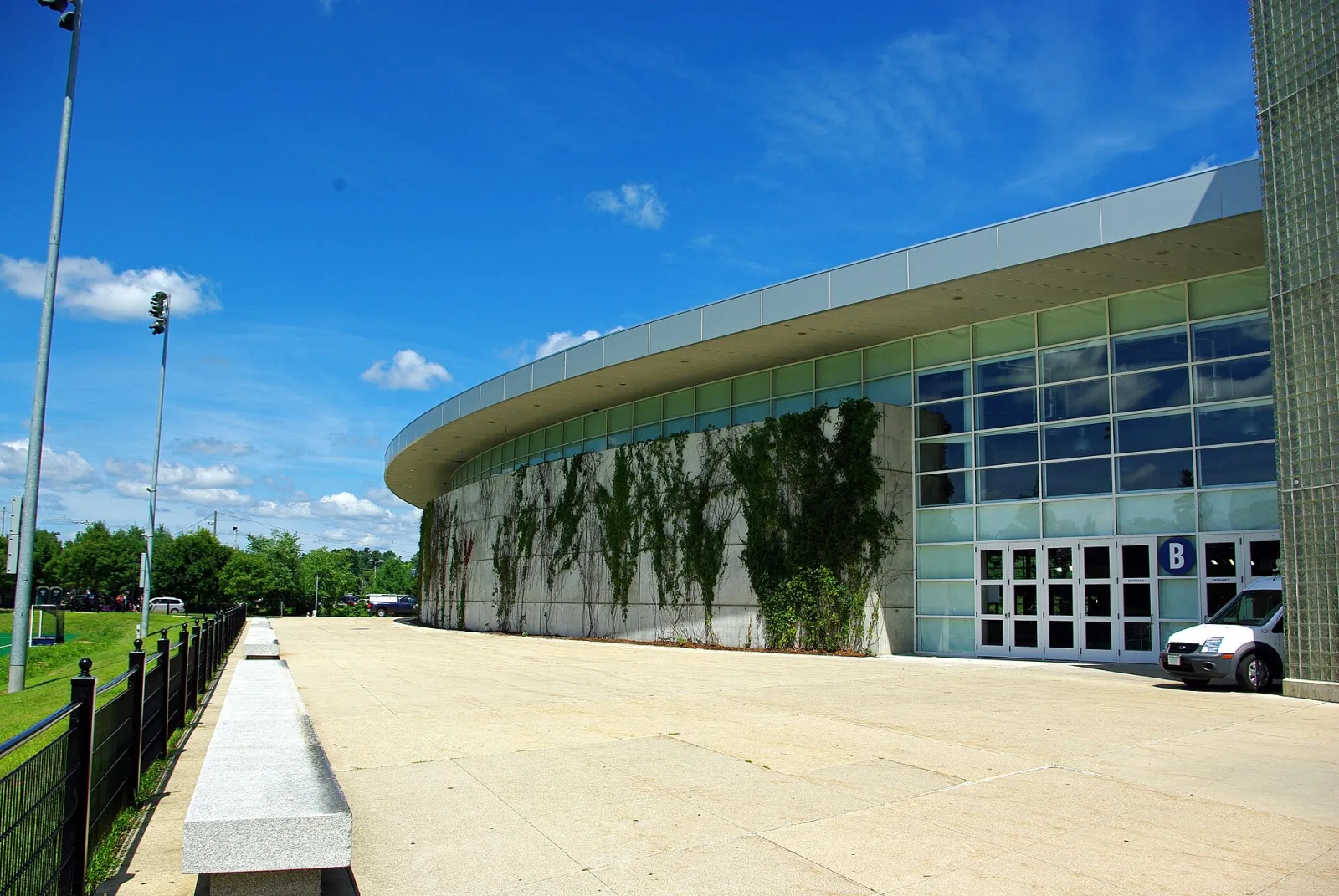 The curved glass and stone front of the Whittemore Center Arena on the University of New Hampshire campus — Whittemore Center Arena