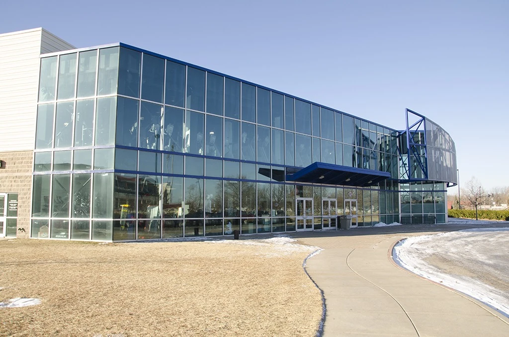Wichita Ice Center’s glass-fronted main entrance and curved approach. — Wichita Ice Center