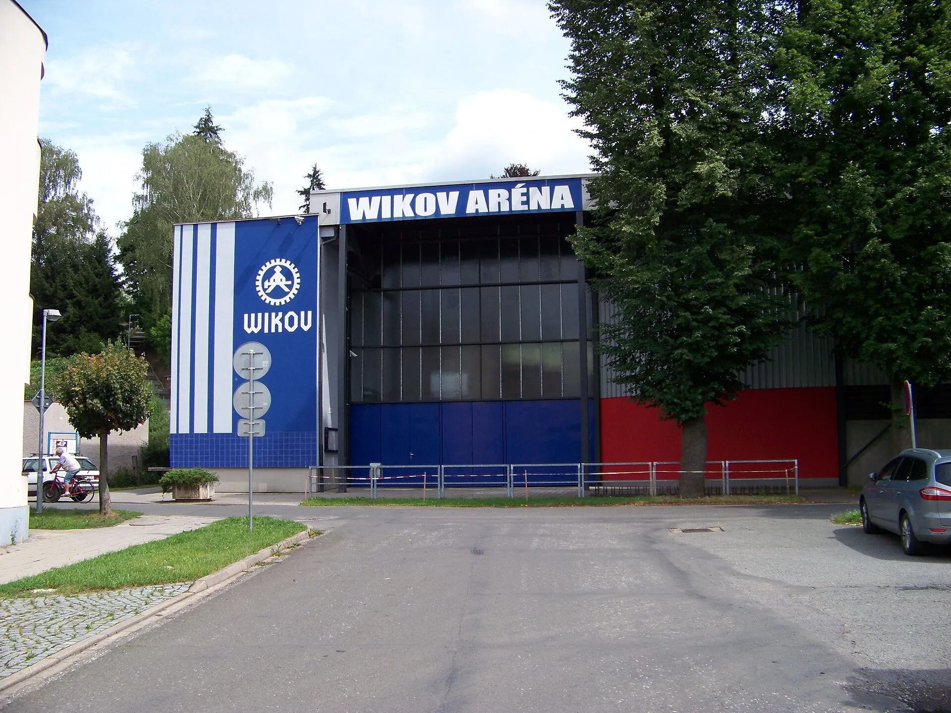 The Palackého street front of the Wikov Aréna in Hronov, with the blue WIKOV panel and the arena name above the entrance — Zimní stadion Hronov (Wikov aréna)