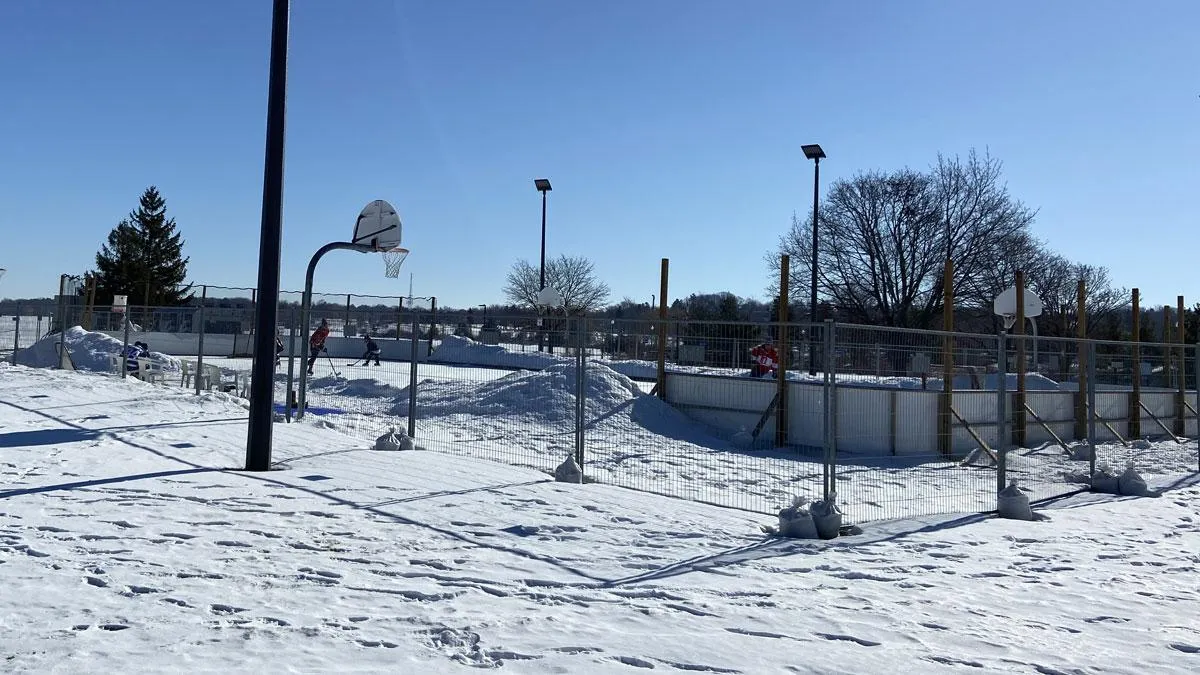 The Will Dwyer Park community rink in Barrie, with boards and light poles around the snowy rink surface. — Will Dwyer Park Community Ice Rink (Barrie)