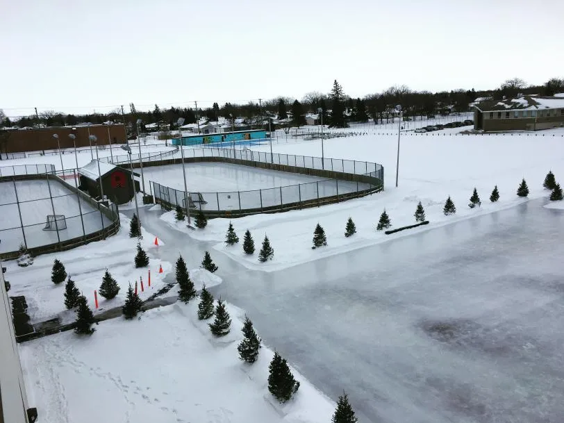 The boarded outdoor hockey rinks at Winakwa Community Centre with fresh ice and snow around them — Winakwa Community Centre Outdoor Rinks