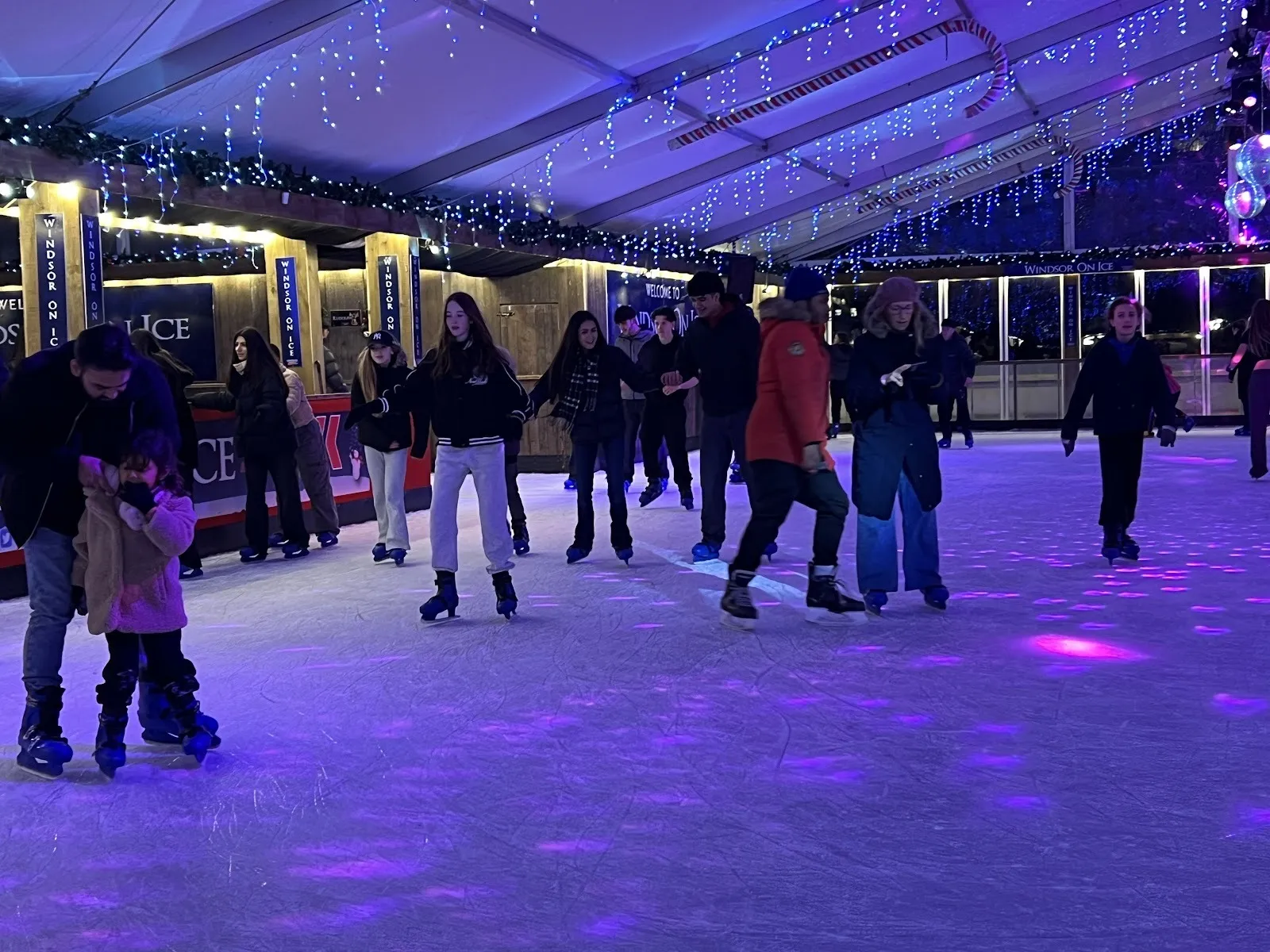 Skaters on the Windsor On Ice rink beneath the white tented roof strung with fairy lights. — Windsor On Ice