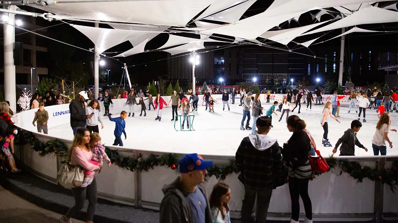 Skaters at the Winter Wonderland Ice Rink under the shade canopy at the Plaza at Mesa City Center — Winter Wonderland Ice Rink