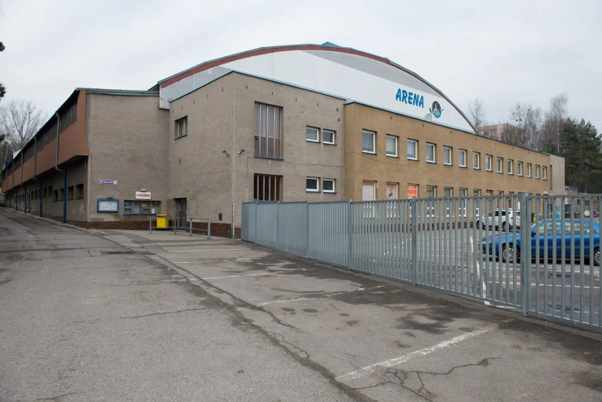 Zimní stadion Orlová seen from the car park, with the ARENA sign on the hall — Zimní stadion Orlová