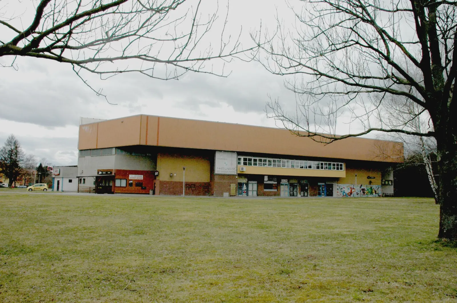 The Studénka winter stadium seen from the lawn in front of it — Zimní stadion Studénka