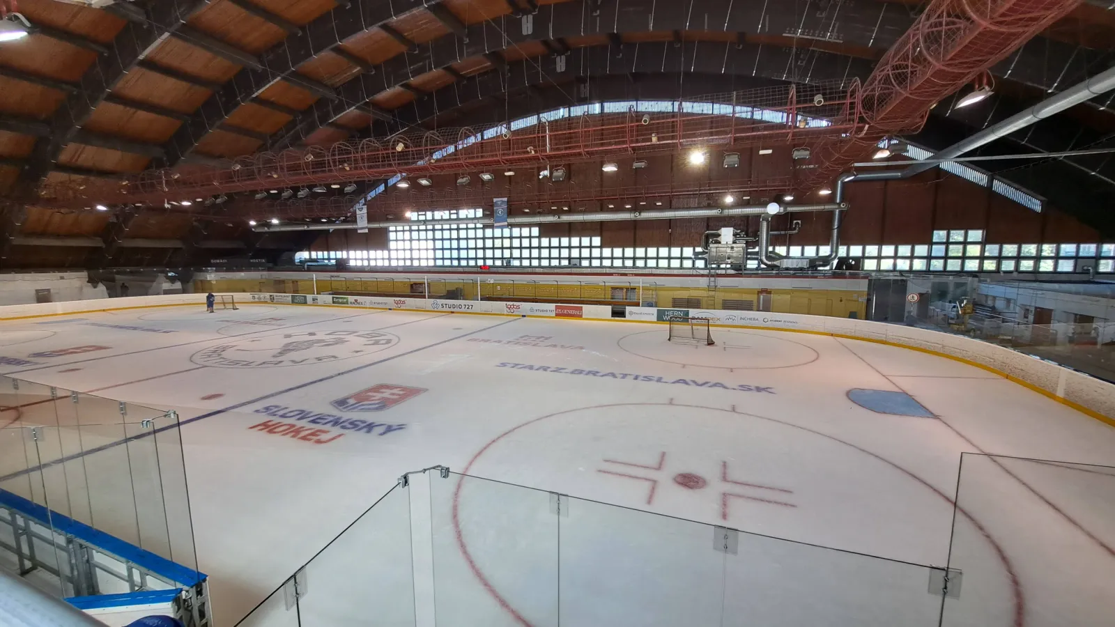 The ice of Zimný štadión Harmincova under its timber arched roof — Zimný štadión Harmincova