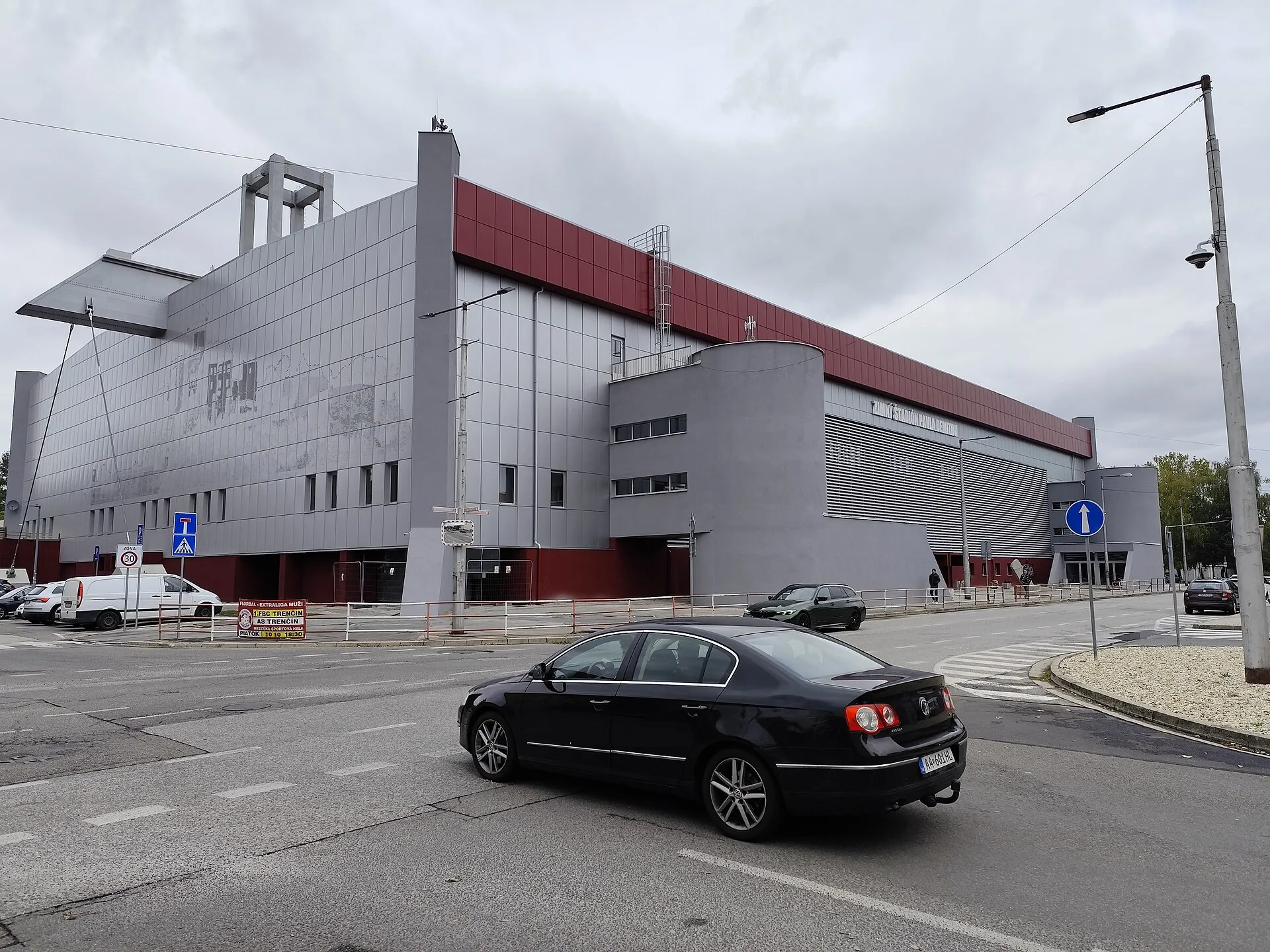The grey and red side of the Pavol Demitra Winter Stadium on Považská street in Trenčín, with the castle mural on the wall — Zimný štadión Pavla Demitru
